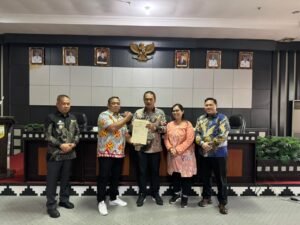 Muhammad Rifai Pinrua menyerahkan 26 sertipikat BMD kepada Bupati Tulang Bawang Barat, Novriwan Jaya, Kamis (09/10/2025).(Foto:Istimewa)